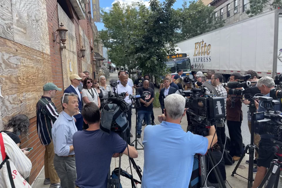 A large group of press and media surround New York City mayoral candidate Eric Adams.